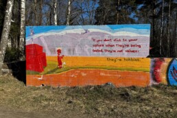 Street art on a concrete wall in Helsinki reading: 