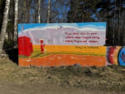 Street art on a concrete wall in Helsinki reading: 